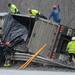 Rescue crews work to secure chains to a turned over trailer as they prepare to lift it upright using two tow trucks. The trailer flipped onto its side, spilling part of its load and pinning another vehicle against the guardrails on south U.S. 23 north of Six Mile Road in Northfield Township on Monday, March 11, 2013. Melanie Maxwell I AnnArbor.com